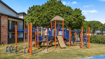 A playground with a slide, swings
